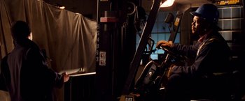 Movie still from “Charlie's Angels: Full Throttle” (2003), directed by McG – A forklift in a room with a cat logo on it; Medium shot, Low angle