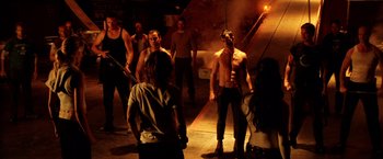 Movie still from “Charlie's Angels: Full Throttle” (2003), directed by McG – A group of people standing in the dark; Wide shot, Over the shoulder angle