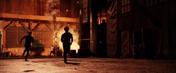 Movie still from “Charlie's Angels: Full Throttle” (2003), directed by McG – A man standing in front of an open door; Wide shot, Low angle