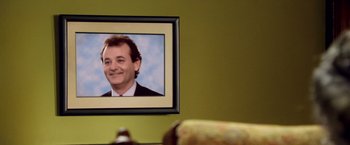 Movie still from “Charlie's Angels: Full Throttle” (2003), directed by McG – A picture of bill murray hanging on the wall; Extreme Close Up shot, Low angle