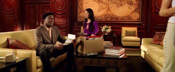 Movie still from “Charlie's Angels: Full Throttle” (2003), directed by McG – Two people sitting in front of a box of books; Medium shot, High angle