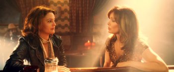 Movie still from “Charlie's Angels: Full Throttle” (2003), directed by McG – Two women sitting at a table in front of each other; Medium shot, Over the shoulder angle