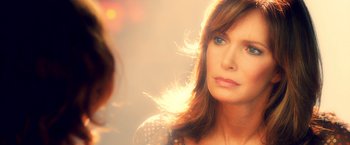 Movie still from “Charlie's Angels: Full Throttle” (2003), directed by McG – A person with long hair looking at the camera; Close Up shot, Over the shoulder angle