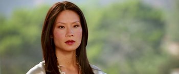 Movie still from “Charlie's Angels: Full Throttle” (2003), directed by McG – A person with long black hair; Close Up shot, Over the shoulder angle