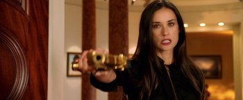 Movie still from “Charlie's Angels: Full Throttle” (2003), directed by McG – A beautiful woman holding a gun in a room; Close Up shot, Over the shoulder angle