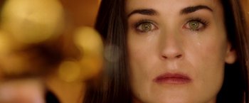 Movie still from “Charlie's Angels: Full Throttle” (2003), directed by McG – A woman's face with a flower in the background; Extreme Close Up shot, Overhead angle