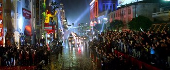 Movie still from “Charlie's Angels: Full Throttle” (2003), directed by McG – A group of people standing on the side of a road at night; Extreme Wide shot, High angle