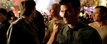 Movie still from “Charlie's Angels: Full Throttle” (2003), directed by McG – A group of men standing next to each other in a room; Close Up shot, Over the shoulder angle