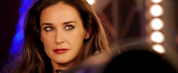 Movie still from “Charlie's Angels: Full Throttle” (2003), directed by McG – A woman's face in a dark room; Close Up shot, Over the shoulder angle