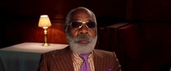 Movie still from “Charlie's Angels: Full Throttle” (2003), directed by McG – An older man wearing a suit and sunglasses; Close Up shot, Low angle