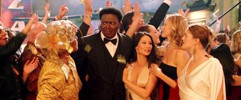 Movie still from “Charlie's Angels: Full Throttle” (2003), directed by McG – A group of people standing around each other at an event; Medium shot, Over the shoulder angle