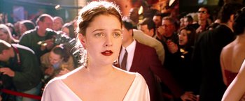 Movie still from “Charlie's Angels: Full Throttle” (2003), directed by McG – A young woman with red lipstick looking at the camera; Close Up shot, Over the shoulder angle