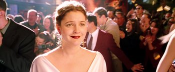 Movie still from “Charlie's Angels: Full Throttle” (2003), directed by McG – A woman in a white dress and a crowd of people in the background; Close Up shot, Over the shoulder angle