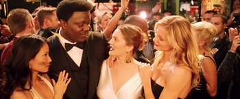 Movie still from “Charlie's Angels: Full Throttle” (2003), directed by McG – A man and two women are smiling at each other; Medium shot, Over the shoulder angle