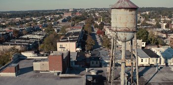 Movie still from “Charm City Kings” (2020), directed by Angel Manuel Soto – An aerial view of a city with a train on the tracks; Extreme Wide shot, High angle