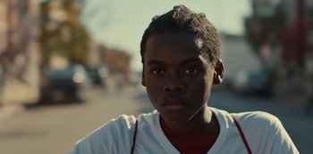 Movie still from “Charm City Kings” (2020), directed by Angel Manuel Soto – A young man's face on the street; Close Up shot, Low angle