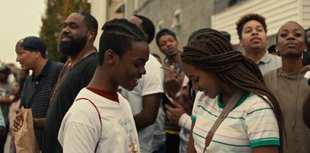 Movie still from “Charm City Kings” (2020), directed by Angel Manuel Soto – A group of young people standing next to each other on the street; Medium shot, Over the shoulder angle