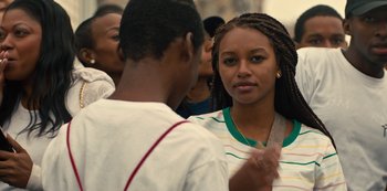 Movie still from “Charm City Kings” (2020), directed by Angel Manuel Soto – A young man and a young woman standing next to each other; Close Up shot, Over the shoulder angle