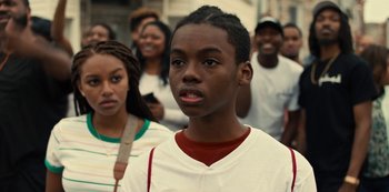 Movie still from “Charm City Kings” (2020), directed by Angel Manuel Soto – A group of young people standing around each other; Close Up shot, Over the shoulder angle