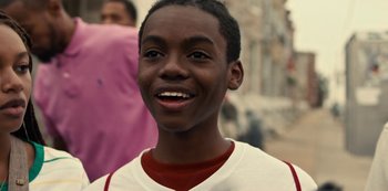 Movie still from “Charm City Kings” (2020), directed by Angel Manuel Soto – A person with a smile on their face; Close Up shot, Low angle