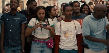 Movie still from “Charm City Kings” (2020), directed by Angel Manuel Soto – A group of young people standing around each other; Medium shot, Over the shoulder angle
