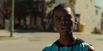 Movie still from “Charm City Kings” (2020), directed by Angel Manuel Soto – A young man is standing on the side of the street; Close Up shot, Low angle