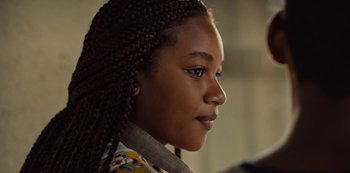 Movie still from “Charm City Kings” (2020), directed by Angel Manuel Soto – A person with braids; Close Up shot, Over the shoulder angle