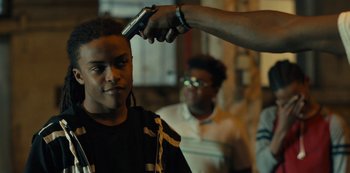 Movie still from “Charm City Kings” (2020), directed by Angel Manuel Soto – A man getting his hair cut by another man; Close Up shot, Over the shoulder angle
