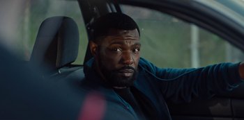 Movie still from “Charm City Kings” (2020), directed by Angel Manuel Soto – A man sitting in the driver's seat of a car; Close Up shot, Over the shoulder angle