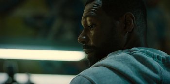 Movie still from “Charm City Kings” (2020), directed by Angel Manuel Soto – A man's face in the dark; Close Up shot, Over the shoulder angle