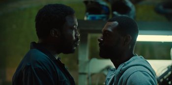 Movie still from “Charm City Kings” (2020), directed by Angel Manuel Soto – Two men face each other in a room; Close Up shot, Over the shoulder angle