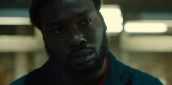 Movie still from “Charm City Kings” (2020), directed by Angel Manuel Soto – A person with a beard looking at the camera; Close Up shot, Over the shoulder angle