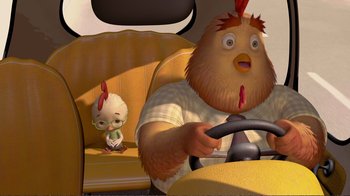 Movie still from “Chicken Little” (2005), directed by Mark Dindal – An image of a chicken in a car with a person in the back of the car; Close Up shot, High angle