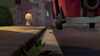 Movie still from “Chicken Little” (2005), directed by Mark Dindal – A small cartoon character standing next to a red truck; Wide shot, High angle
