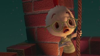 Movie still from “Chicken Little” (2005), directed by Mark Dindal – A chicken wearing glasses standing next to a brick wall; Close Up shot, High angle