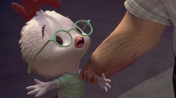 Movie still from “Chicken Little” (2005), directed by Mark Dindal – An animated cat wearing a pair of green glasses and holding hands with a person; Medium shot, Over the shoulder angle