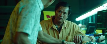 Movie still from “Child's Play” (2019), directed by Lars Klevberg – A man standing next to another man in a room; Close Up shot, Over the shoulder angle