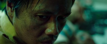 Movie still from “Child's Play” (2019), directed by Lars Klevberg – A man's face with green paint on his face; Extreme Close Up shot, Low angle