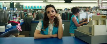 Movie still from “Child's Play” (2019), directed by Lars Klevberg – A woman sitting at a table in a store; Medium shot, Over the shoulder angle