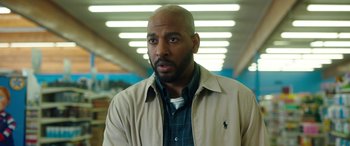 Movie still from “Child's Play” (2019), directed by Lars Klevberg – A man in a tan jacket and a plaid shirt; Close Up shot, Over the shoulder angle