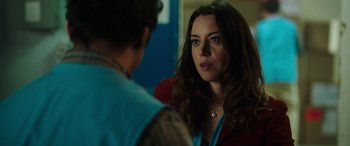 Movie still from “Child's Play” (2019), directed by Lars Klevberg – A woman in a red jacket is looking at a man; Close Up shot, Over the shoulder angle