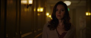 Movie still from “Child's Play” (2019), directed by Lars Klevberg – A woman standing in a room with lights in the background; Close Up shot, Over the shoulder angle