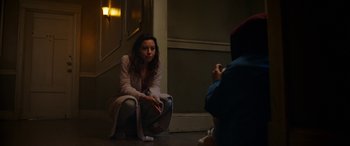 Movie still from “Child's Play” (2019), directed by Lars Klevberg – A woman sitting on the ground taking a picture of another woman; Wide shot, High angle