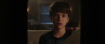 Movie still from “Child's Play” (2019), directed by Lars Klevberg – A young boy is looking at the camera; Close Up shot, Over the shoulder angle