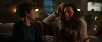 Movie still from “Child's Play” (2019), directed by Lars Klevberg – A woman sitting next to a boy on a couch; Close Up shot, Over the shoulder angle