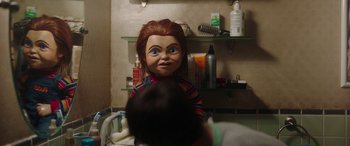 Movie still from “Child's Play” (2019), directed by Lars Klevberg – A child's play chucky doll in a room; Medium shot, Over the shoulder angle