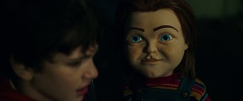 Movie still from “Child's Play” (2019), directed by Lars Klevberg – A chucky doll with a person looking at it; Close Up shot, Over the shoulder angle