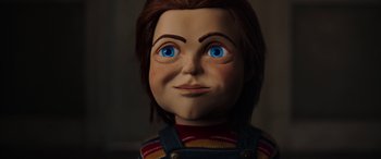 Movie still from “Child's Play” (2019), directed by Lars Klevberg – The face of a chucky doll with blue eyes; Close Up shot, Low angle