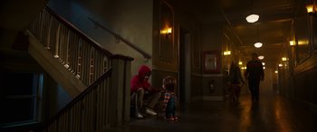Movie still from “Child's Play” (2019), directed by Lars Klevberg – A man sitting on the floor next to a little girl; Wide shot, Over the shoulder angle