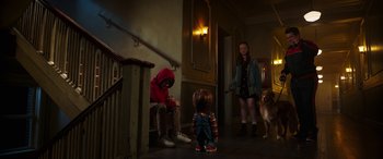 Movie still from “Child's Play” (2019), directed by Lars Klevberg – Two children and a dog in a hallway; Wide shot, Over the shoulder angle